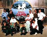En combinaison de pilote, en haut à gauche, au Space Camp Patrick Baudry à Mandelieu, avec des enfants handicapés (1990)
